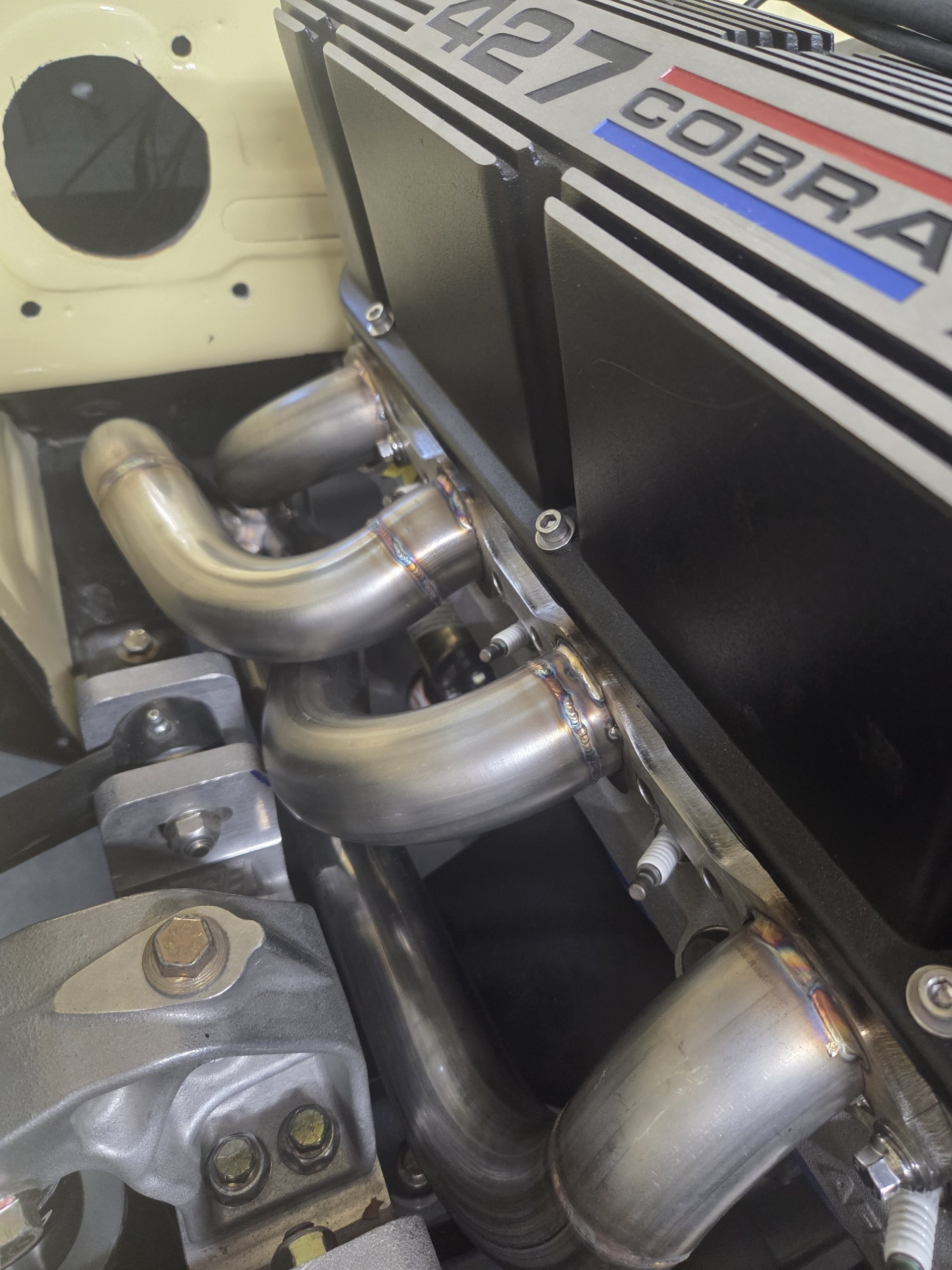 Custom TIG-welded stainless headers on a 427 Cobra — built in-house